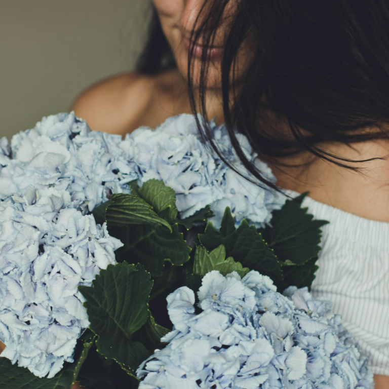 A person holding blue hydrangea flowers in Dubai